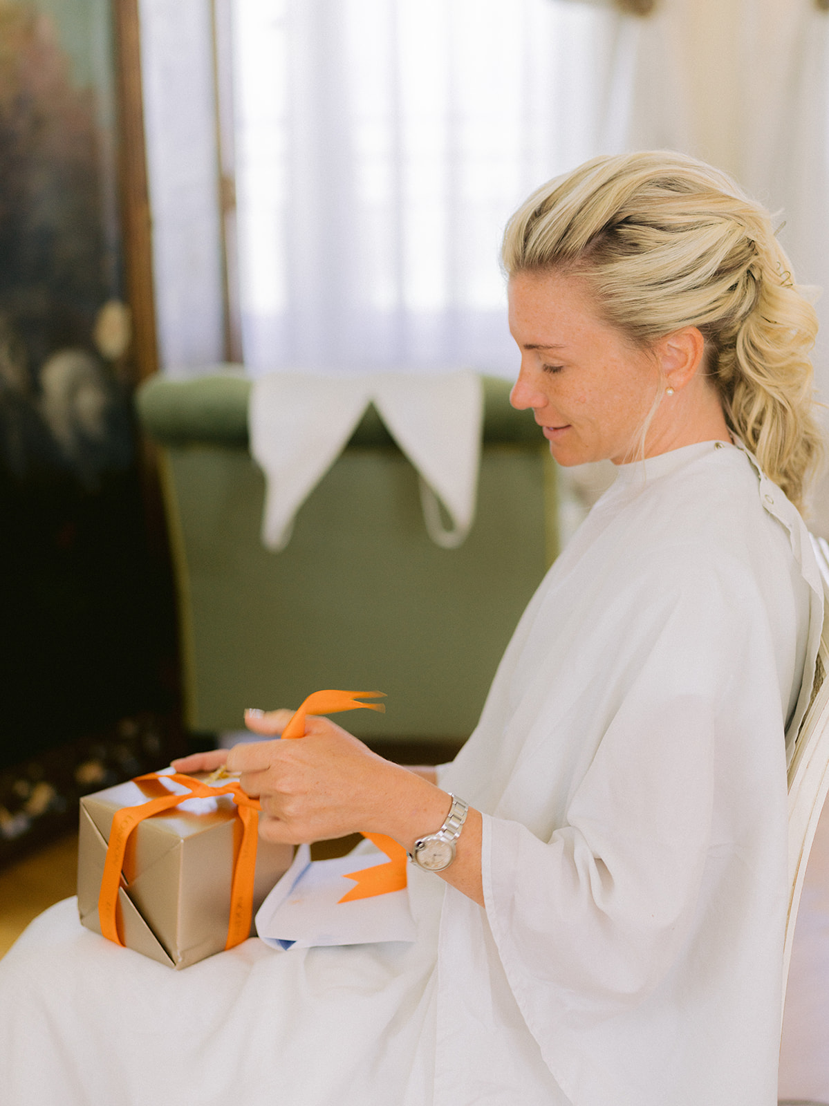 a bride recieves a gift during her getting ready